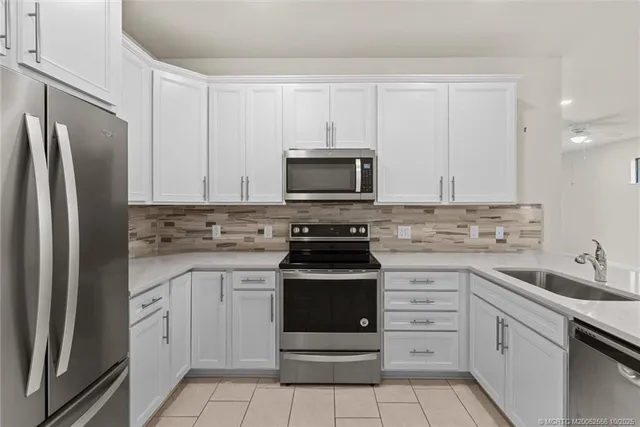 an empty room with a window and ceiling fan
