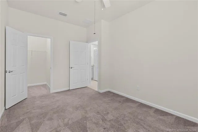 a view of a room with wooden floor and iron stairs