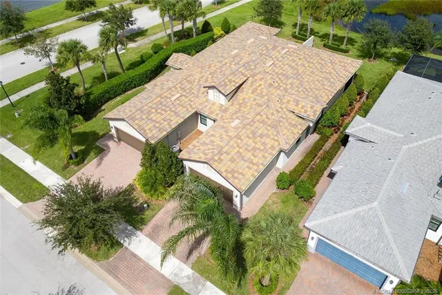 an aerial view of residential houses with outdoor space and river