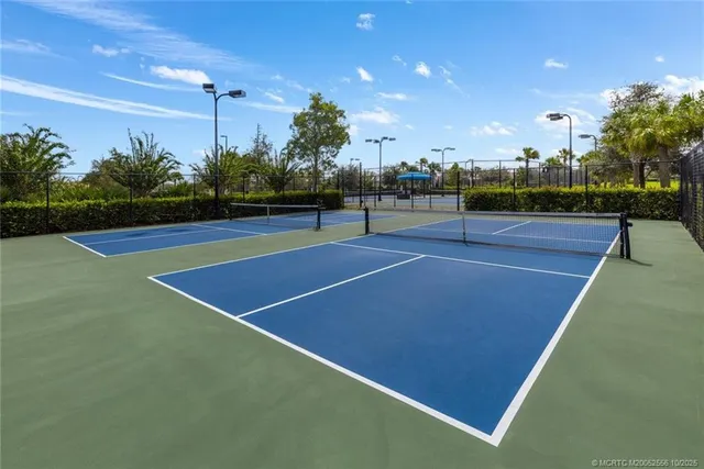 a outdoor space with lots of tables a large window and chairs