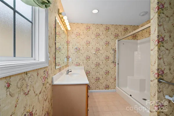 a bathroom with a shower and a sink