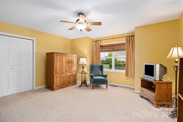 a view of a livingroom with workspace and a window