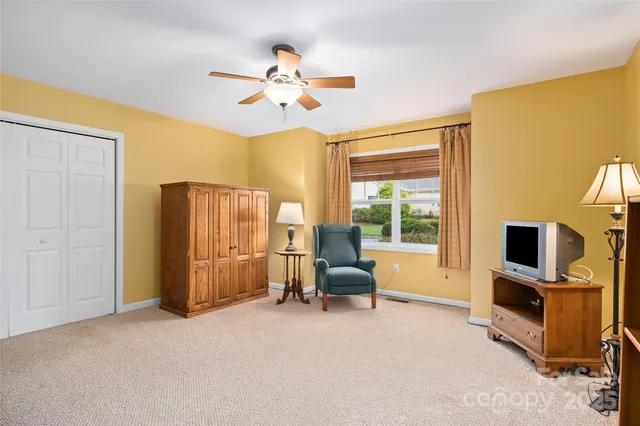 a view of a livingroom with workspace and a window