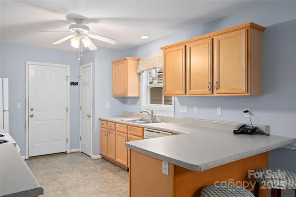 a kitchen that has a sink a stove and a window
