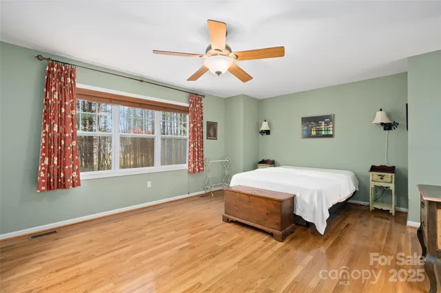 a spacious bedroom with a bed and a window