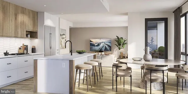 a kitchen with stainless steel appliances kitchen island granite countertop a table chairs in it and white cabinets