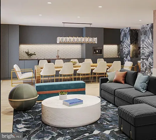 a living room with furniture and kitchen view