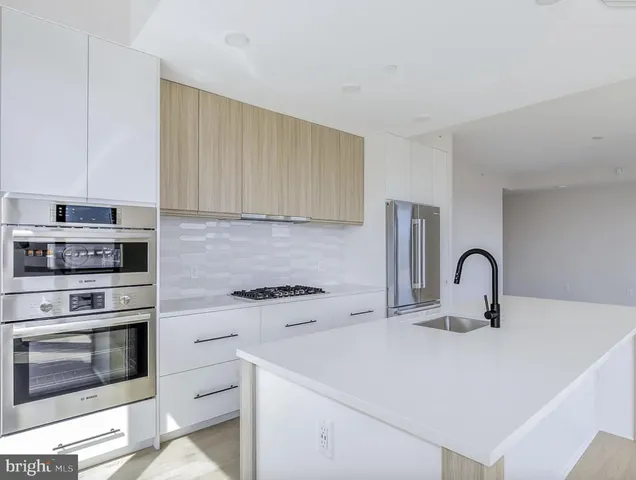 a kitchen with a stove a sink and a microwave