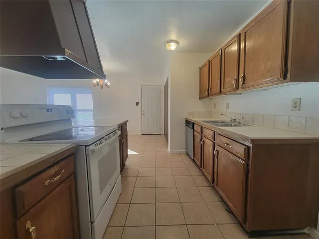 a kitchen with stainless steel appliances granite countertop a sink and cabinets