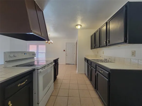 a kitchen with a sink stove and cabinets