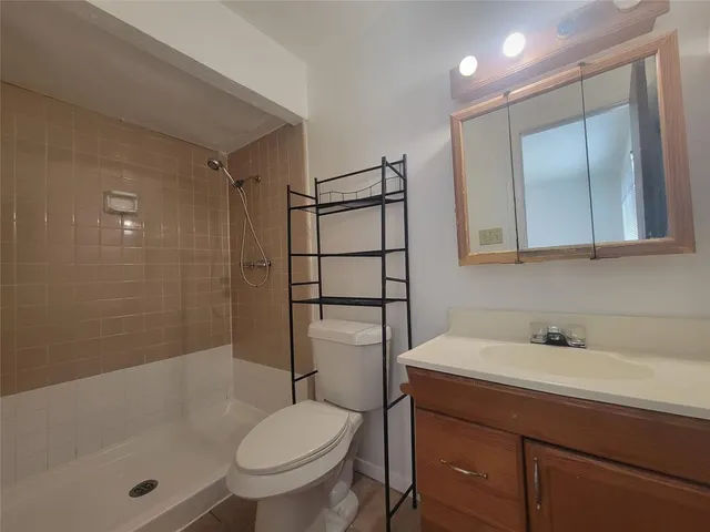 a bathroom with a sink toilet and shower