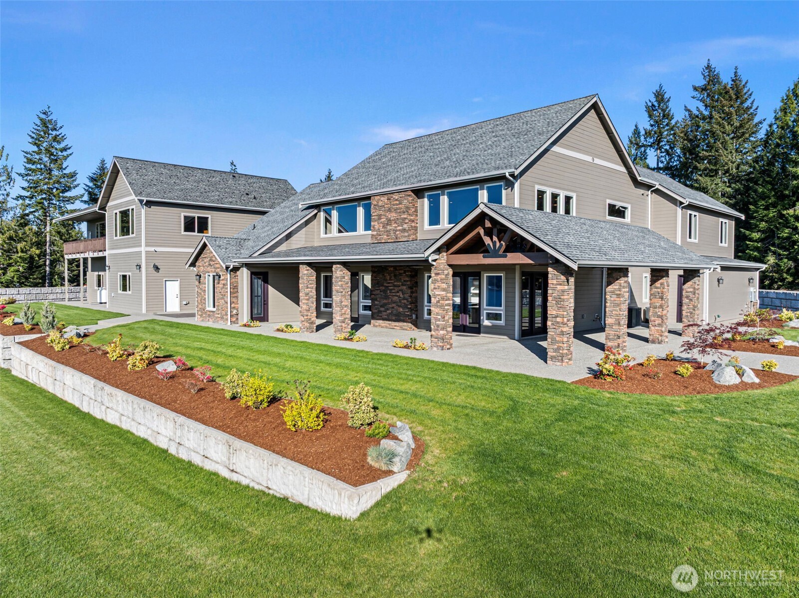 151 East Windy Ridge Lane Belfair, WA 98528 - Photo 37 of 40 a front view of a house with garden and porch
