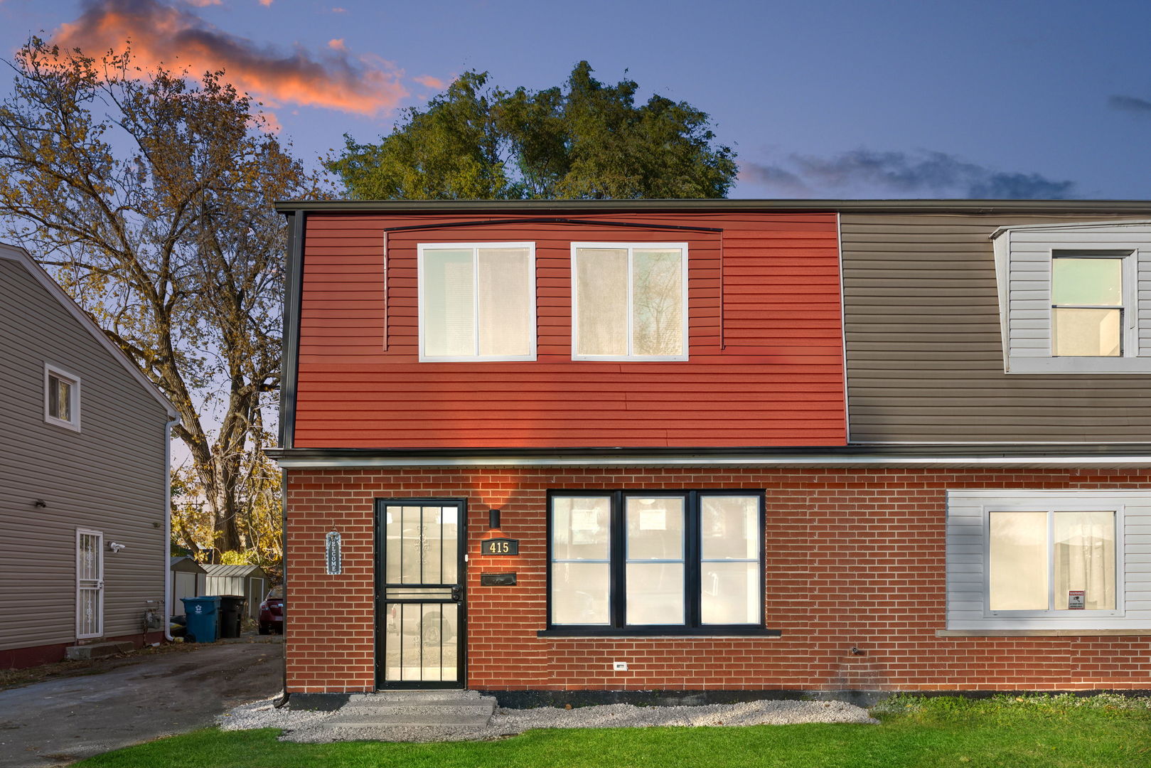 a front view of a house with a yard