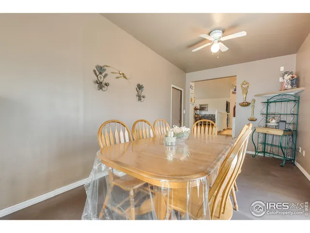 a view of a dining room with furniture and a chandelier