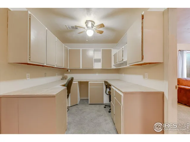 a view of a kitchen with a sink and cabinets