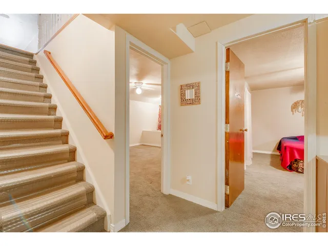 a view of an empty room and a ceiling fan