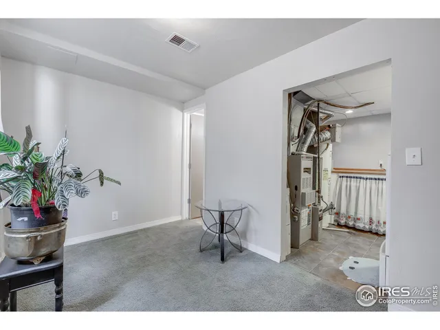 a view of a livingroom with furniture and staircase