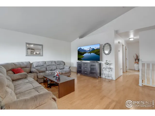 a living room with furniture and kitchen view