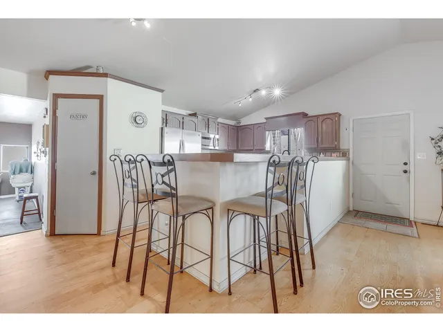 a kitchen with stainless steel appliances granite countertop a stove top oven a sink dishwasher and cabinets with wooden floor