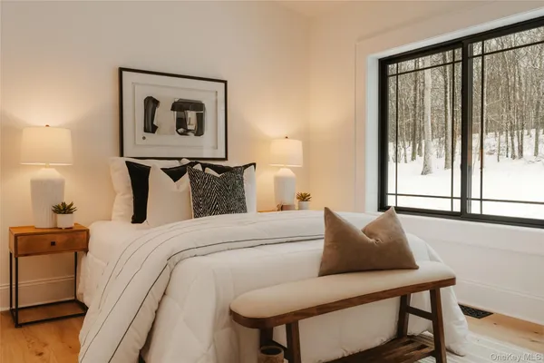 a bedroom with a bed and glass window