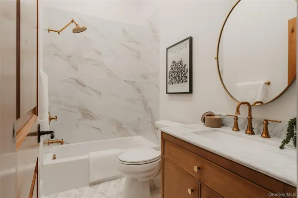 a bathroom with a sink a toilet and a mirror
