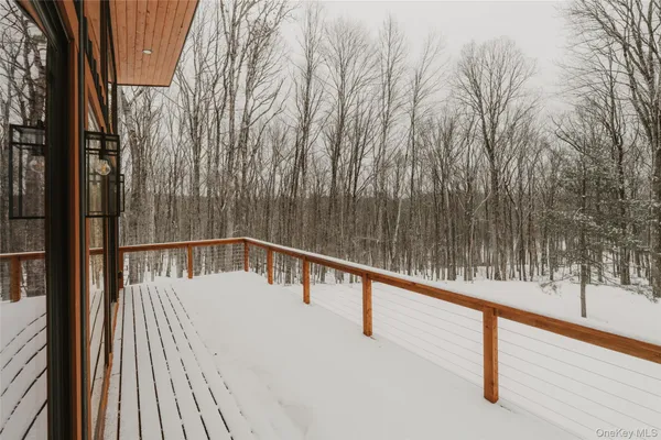 a view of balcony with wooden floor and fence
