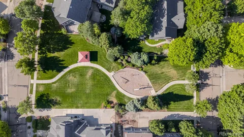an aerial view of a house with swimming pool and outdoor seating