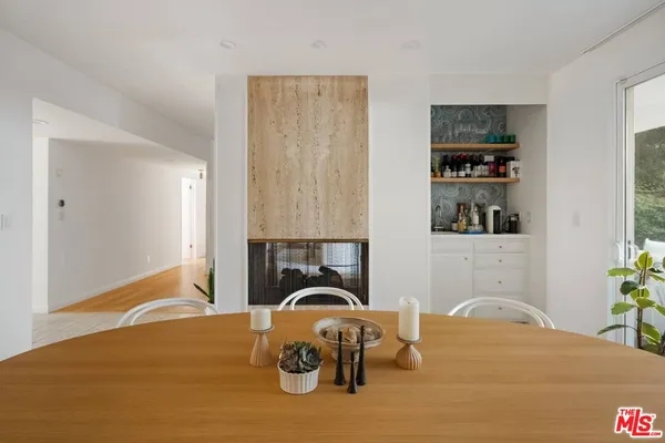 a bedroom with a bed and a potted plant on the dresser