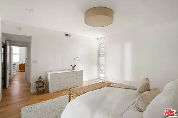 a bedroom with a bed and a chandelier