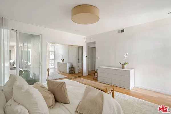a bedroom with a bed and chandelier