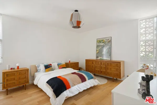 a bedroom with a bed and cabinets