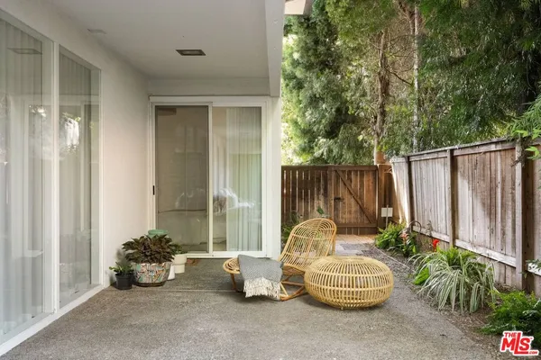 a view of backyard with swimming pool and outdoor seating