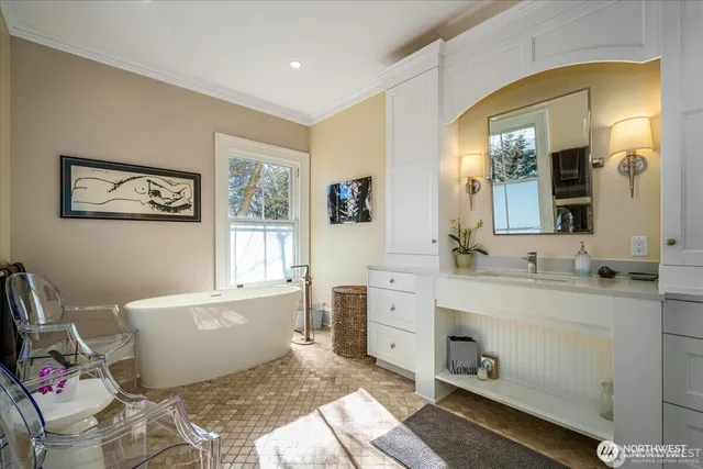 a spacious bathroom with a tub sink and mirror