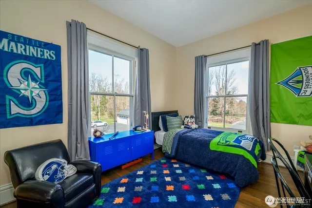 a bedroom with two beds and a window