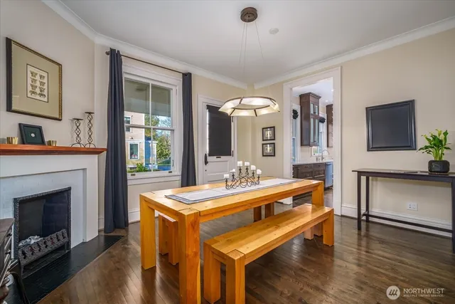 a view of a dining room with furniture a chandelier and wooden floor