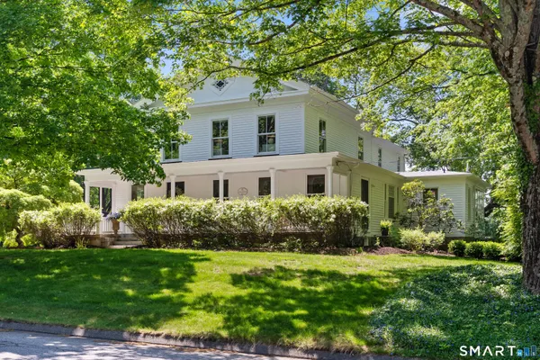 a front view of house with yard and green space