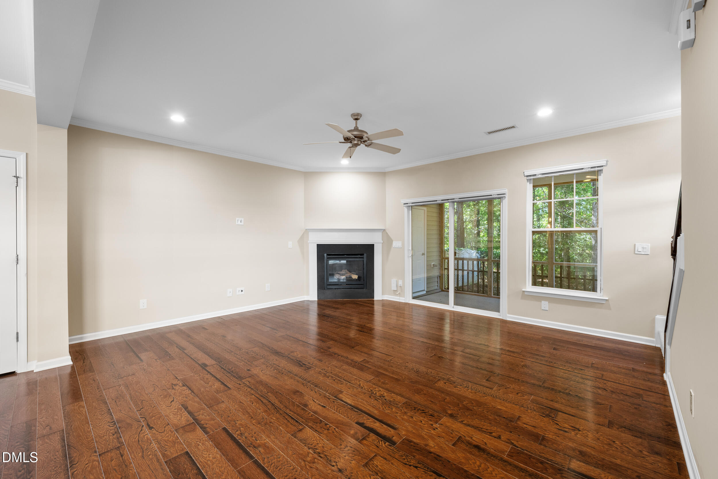 1217 Silver Beach Way Raleigh, NC 27606 - Photo 11 of 32 a view of an empty room with wooden floor and a window