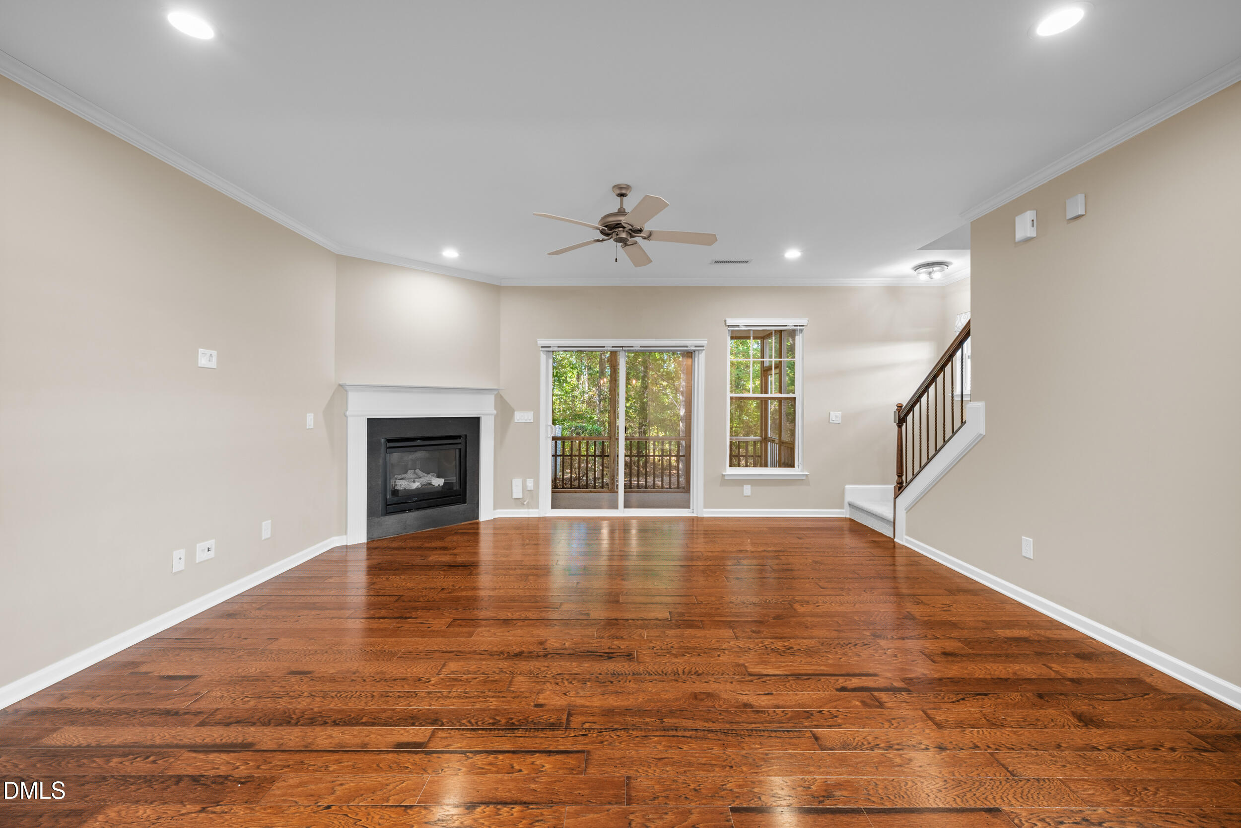 1217 Silver Beach Way Raleigh, NC 27606 - Photo 12 of 32 a view of an empty room with wooden floor and a window
