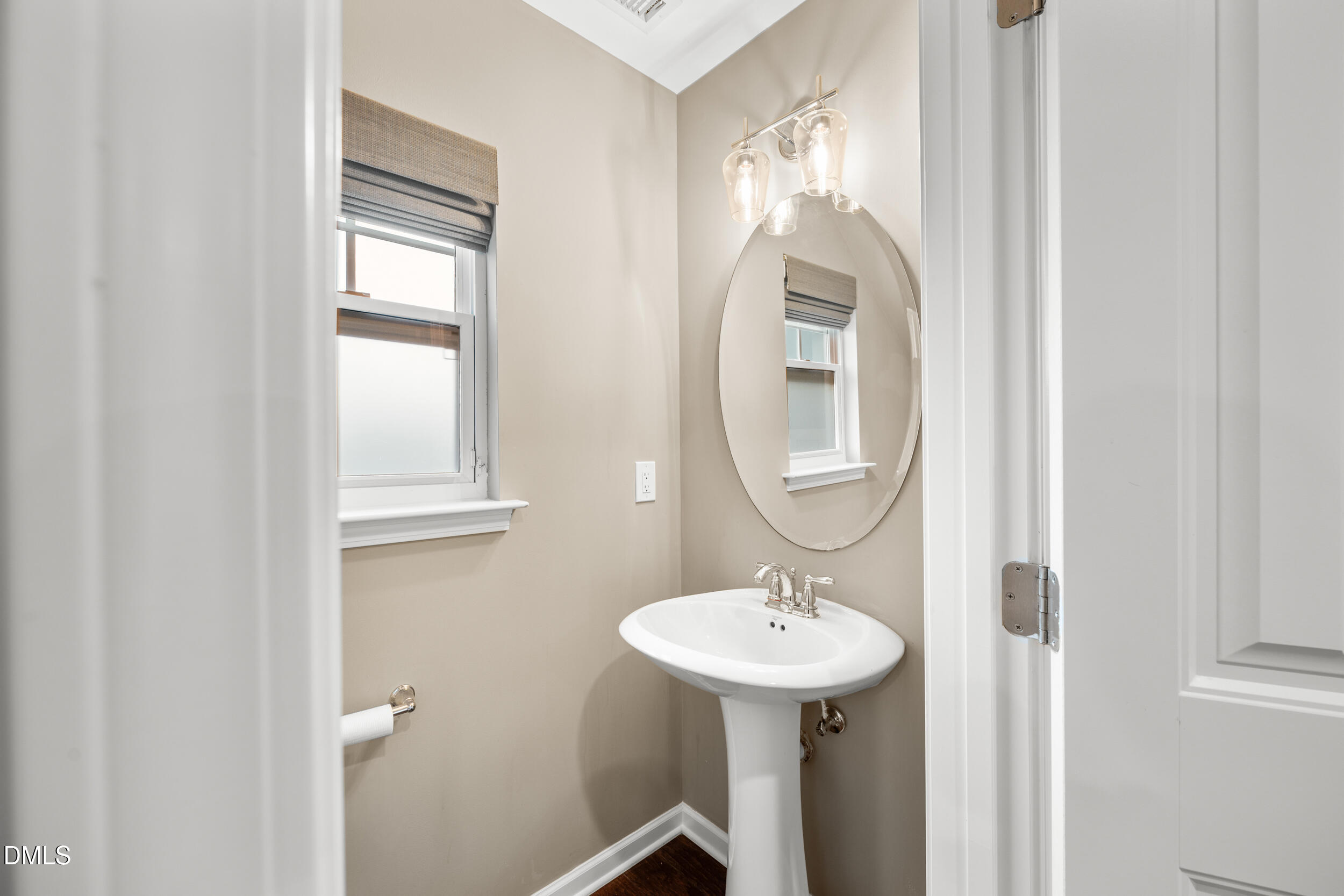 1217 Silver Beach Way Raleigh, NC 27606 - Photo 14 of 32 a bathroom with a sink and a mirror