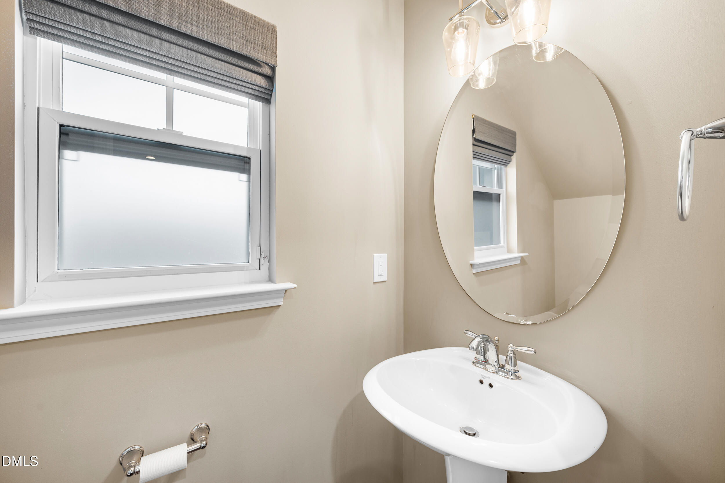 1217 Silver Beach Way Raleigh, NC 27606 - Photo 15 of 32 a bathroom with a sink and a mirror