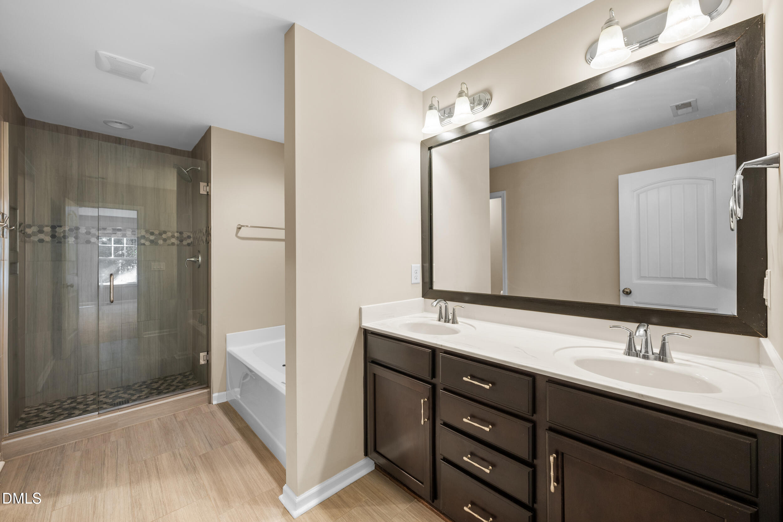 1217 Silver Beach Way Raleigh, NC 27606 - Photo 22 of 32 a bathroom with a double vanity sink a and mirror