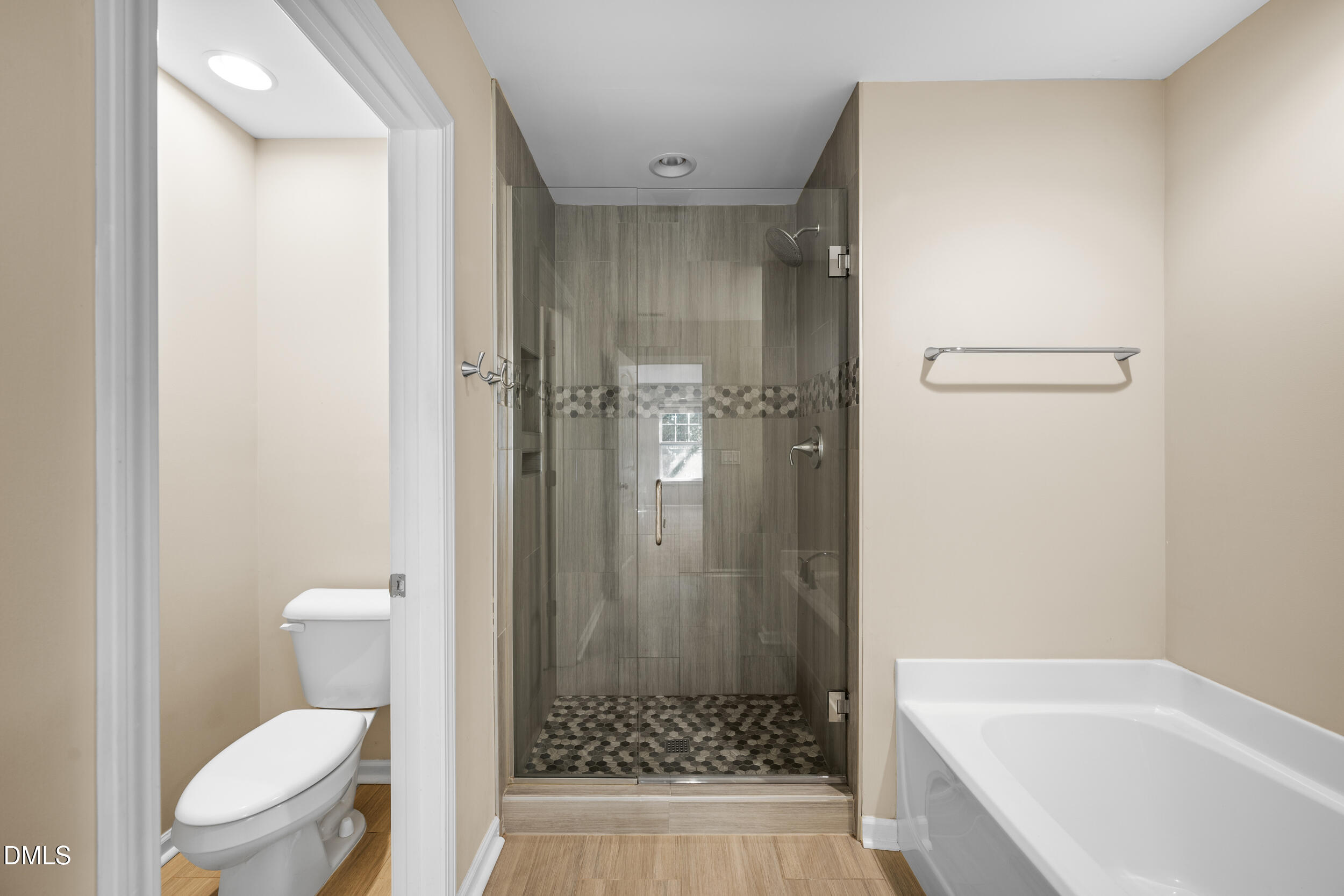 1217 Silver Beach Way Raleigh, NC 27606 - Photo 24 of 32 a bathroom with a granite countertop toilet a sink a shower and a mirror