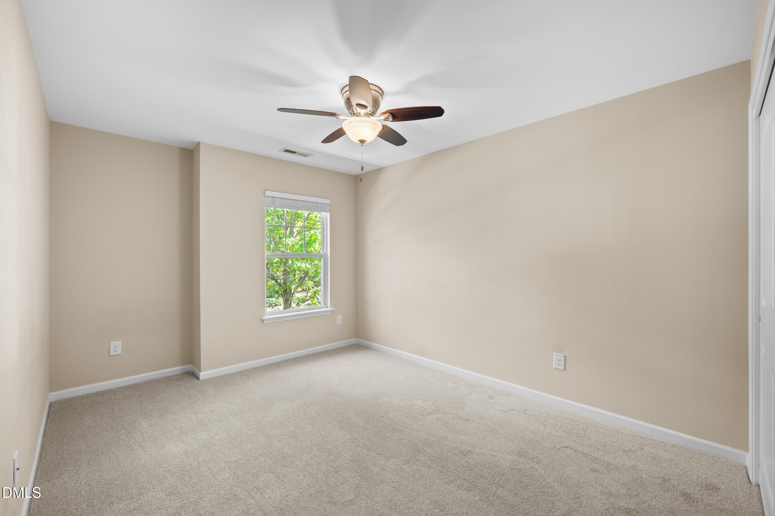 1217 Silver Beach Way Raleigh, NC 27606 - Photo 27 of 32 an empty room with windows and fan