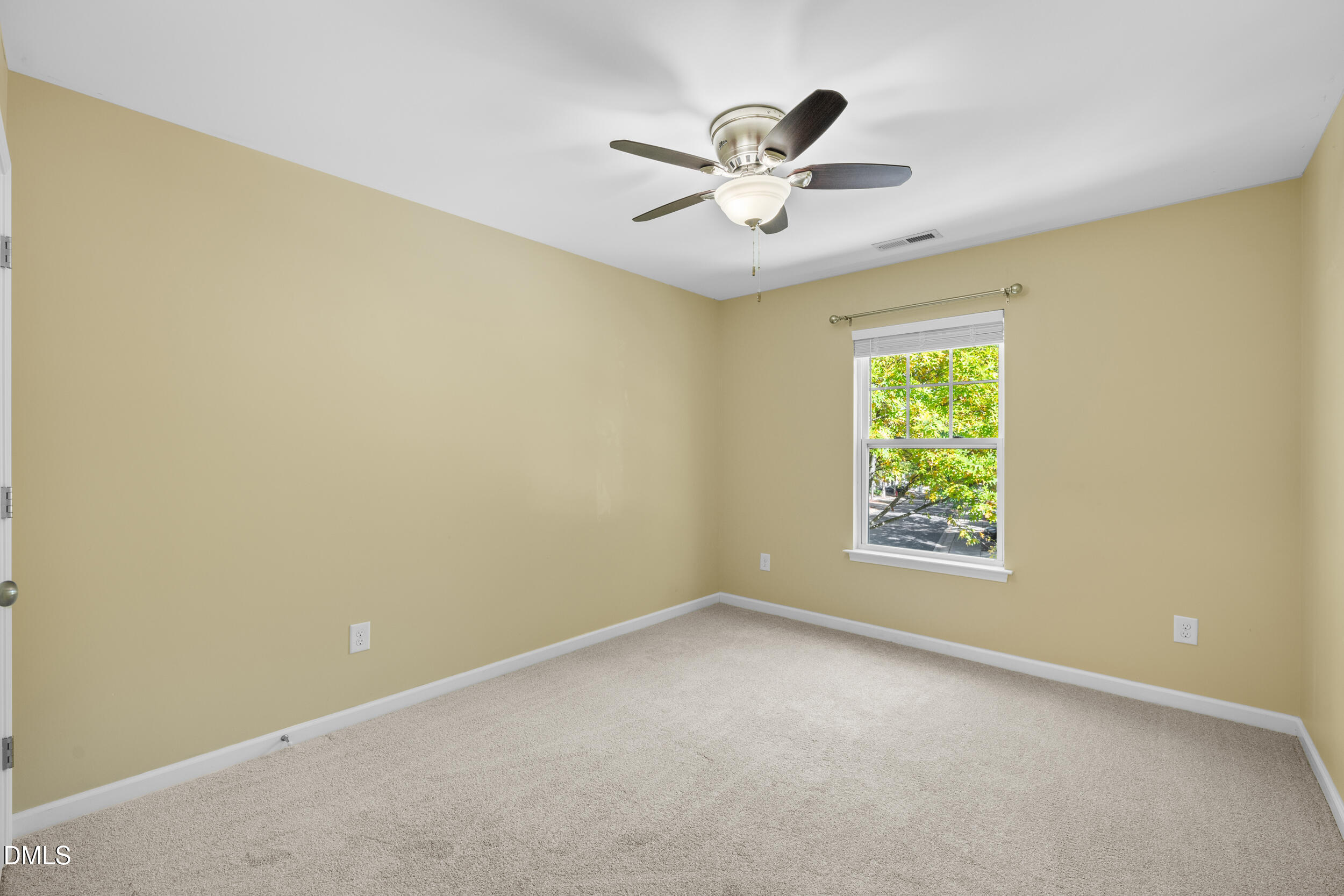 1217 Silver Beach Way Raleigh, NC 27606 - Photo 28 of 32 an empty room with a window and a fan