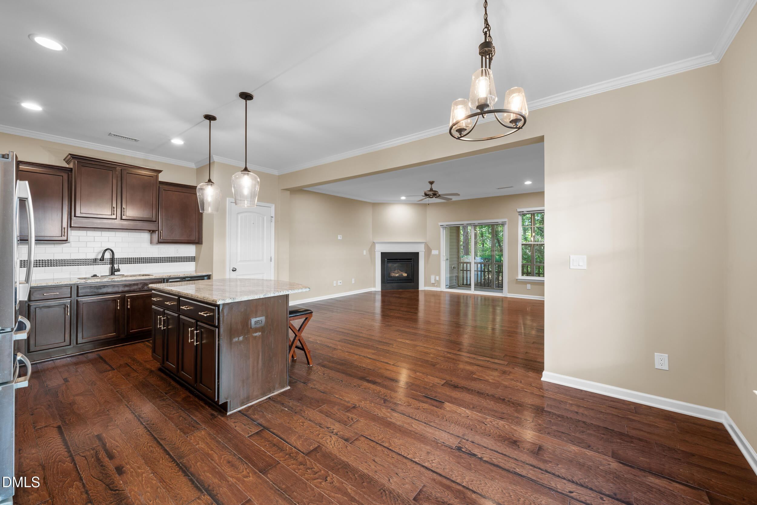 1217 Silver Beach Way Raleigh, NC 27606 - Photo 4 of 32 a kitchen with stainless steel appliances granite countertop a stove and cabinets with wooden floor