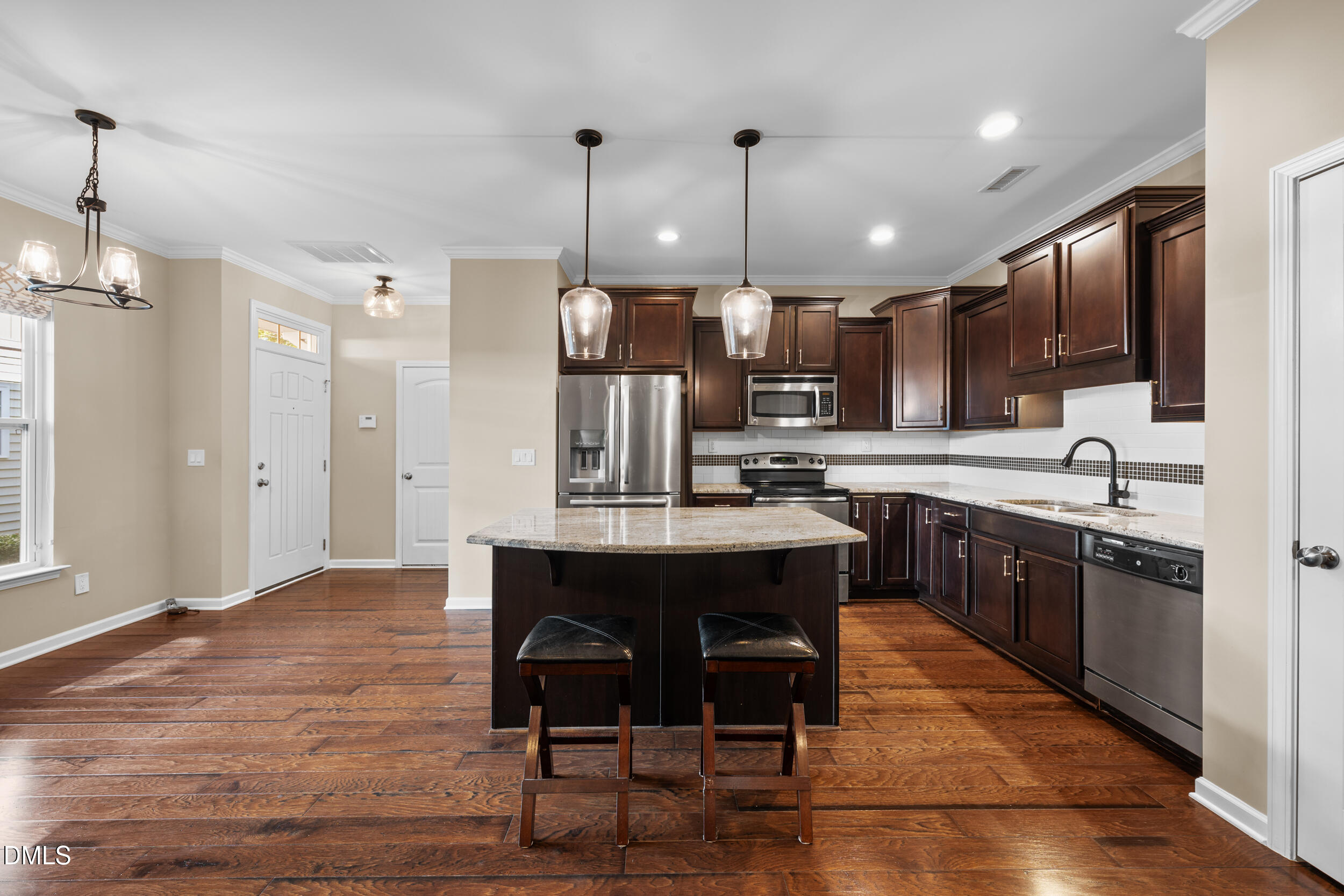 1217 Silver Beach Way Raleigh, NC 27606 - Photo 7 of 32 a large kitchen with a table and chairs