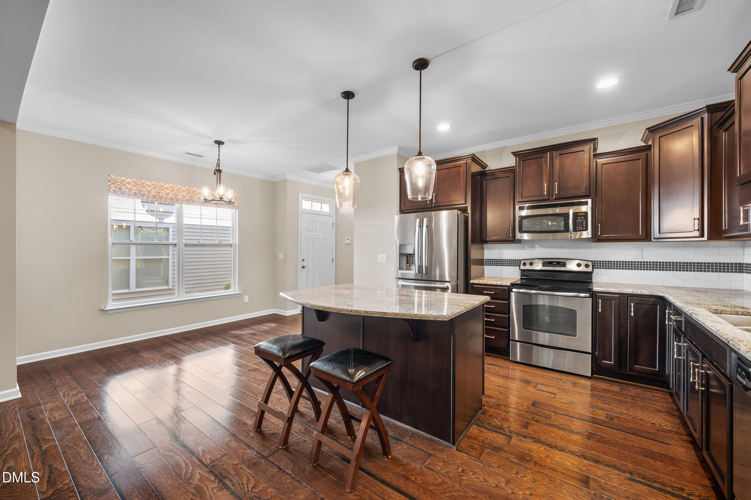 1217 Silver Beach Way Raleigh, NC 27606 - Photo 8 of 32 a kitchen with stainless steel appliances granite countertop a stove a sink dishwasher a refrigerator and wooden floor