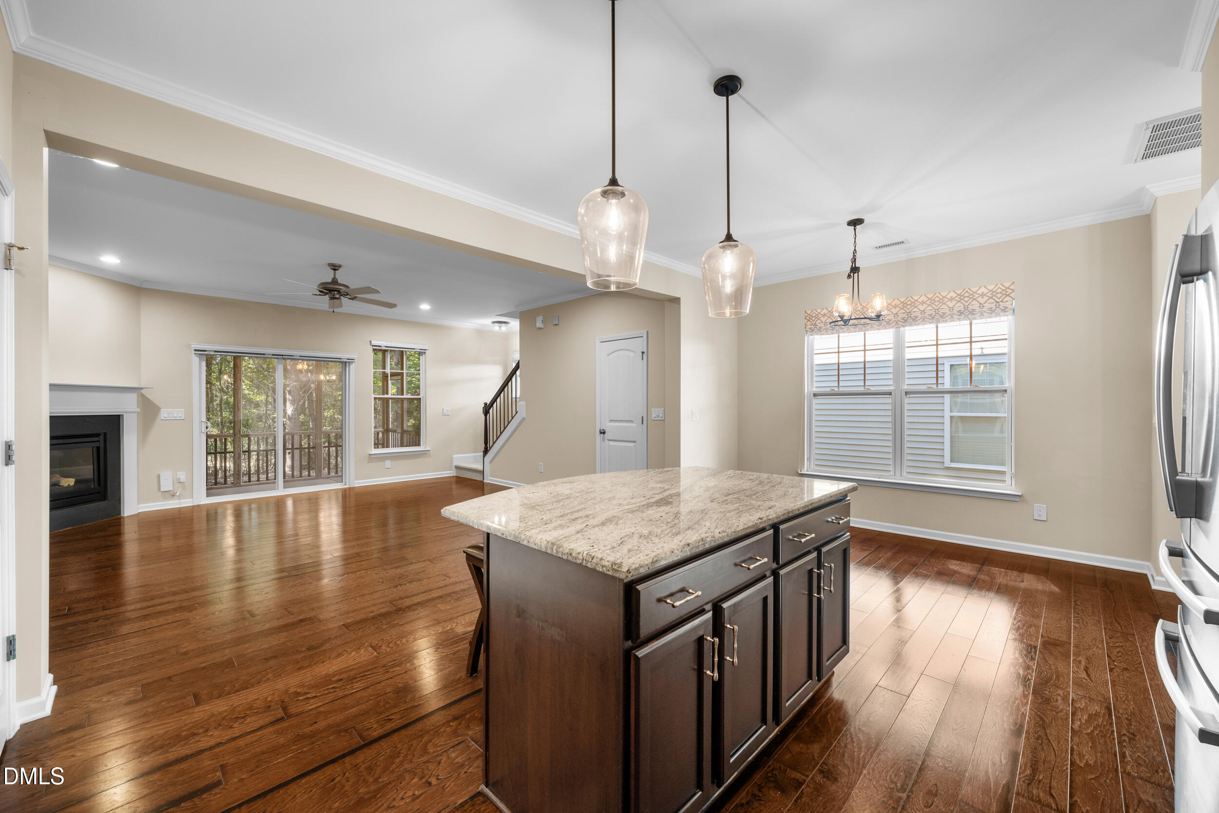 1217 Silver Beach Way Raleigh, NC 27606 - Photo 9 of 32 a kitchen with a wooden floor window and a clock