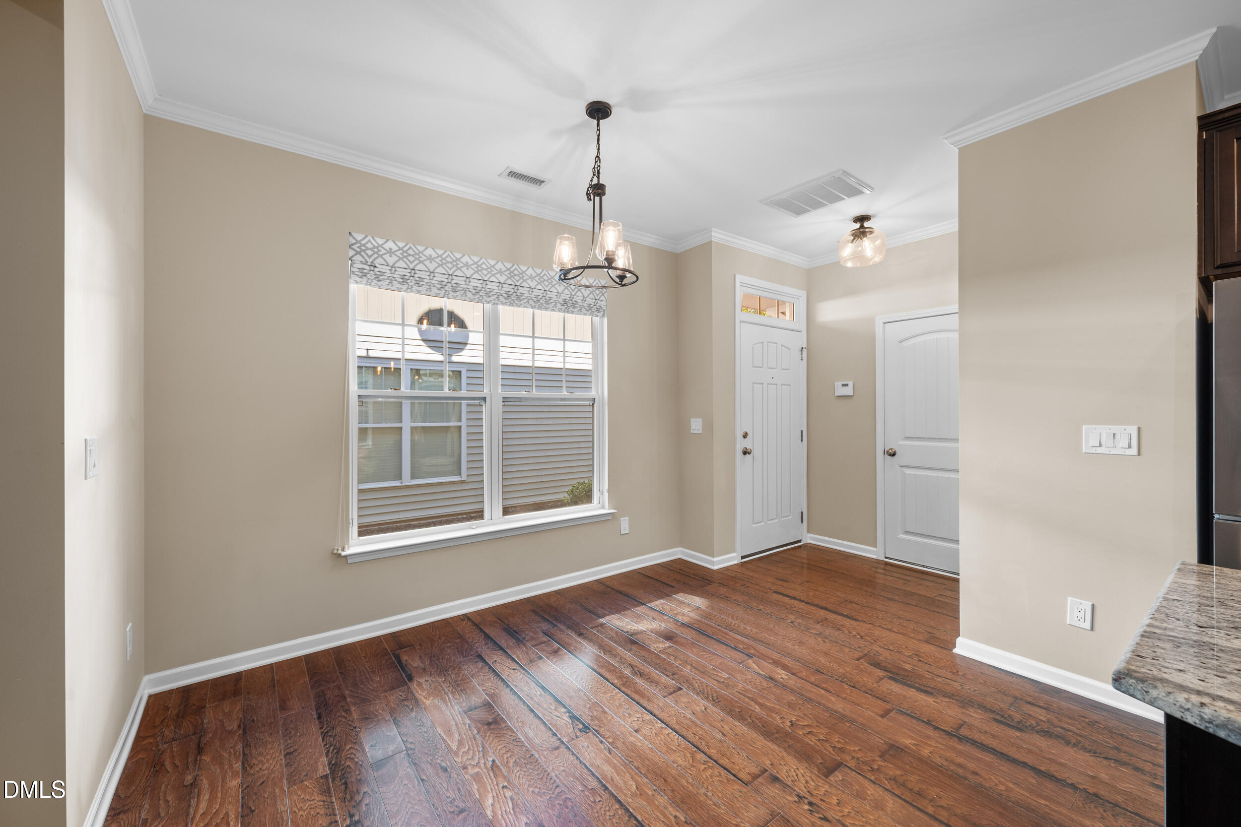 1217 Silver Beach Way Raleigh, NC 27606 - Photo 10 of 32 a view of an empty room with wooden floor and a window