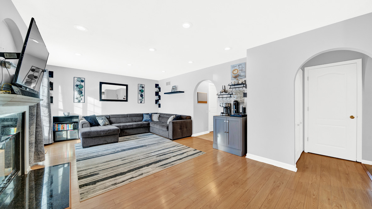 Undisclosed Address Palatine, IL 60067 - Photo 12 of 27 a living room with furniture a flat screen tv and a fireplace